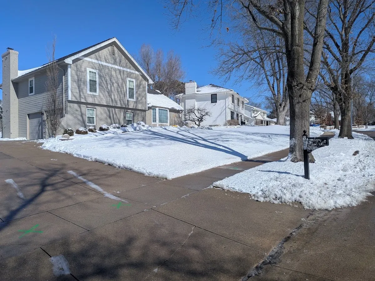 Snow-covered property and cleared drive