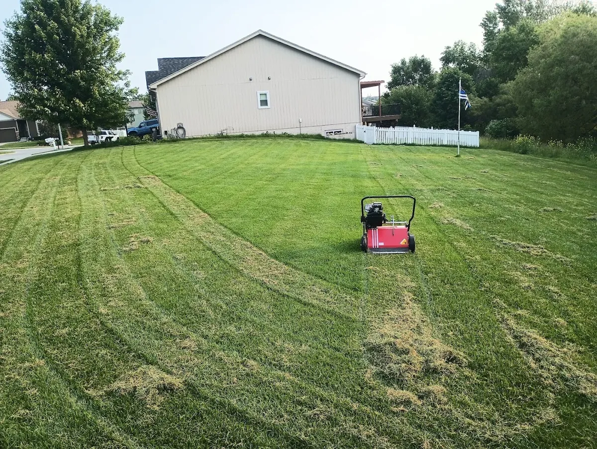 Striped mowed lawn with lawn-care equipment